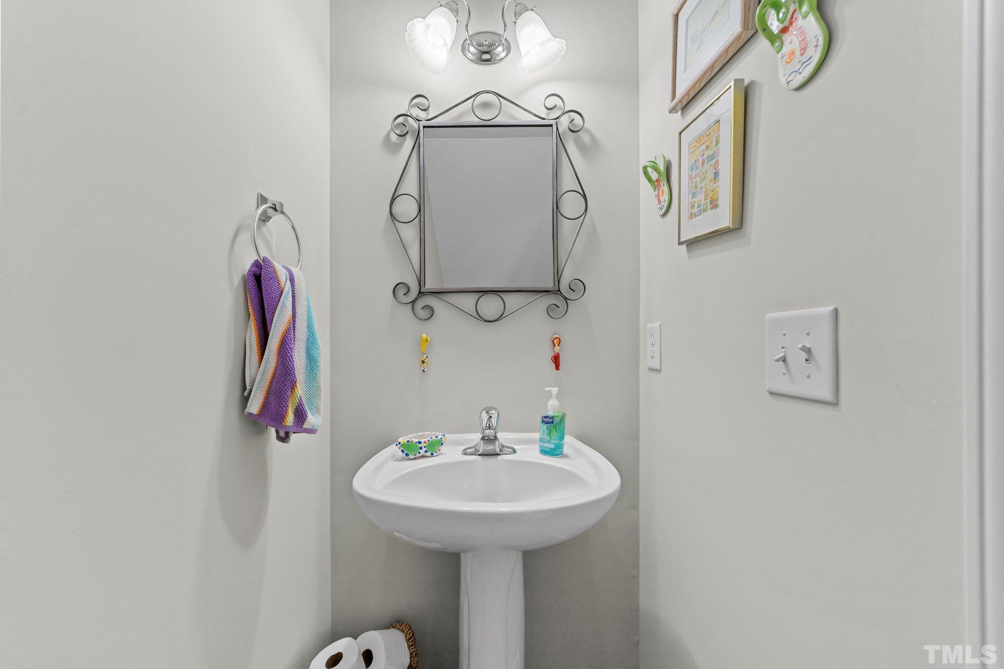 4728 Altha Street Raleigh, NC 27606 - Photo 9 of 31 a bathroom with a sink and a mirror