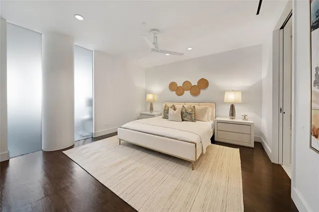 a bedroom with a bed and a potted plant