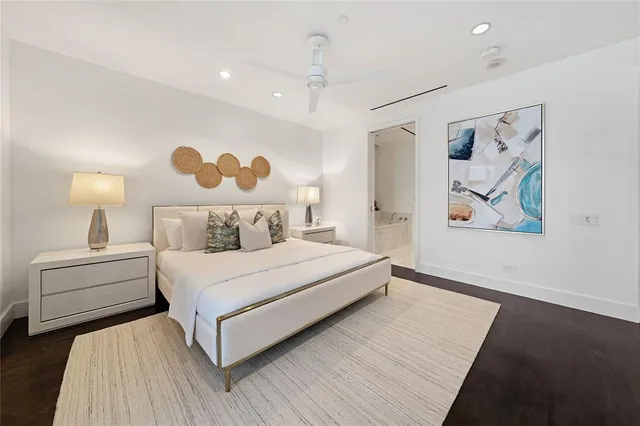 a bedroom with a large bed and a chandelier