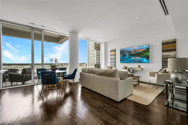 a living room with furniture window and wooden floor
