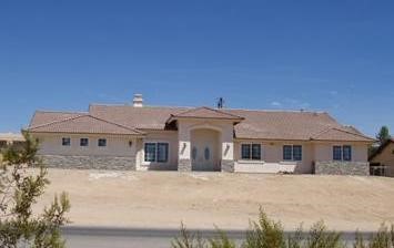 14871 Apple Valley Road Apple Valley, CA 92307 - Photo 1 of 1 a front view of a house with a yard