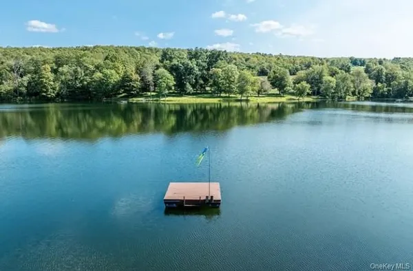 a view of a lake with a house in the background