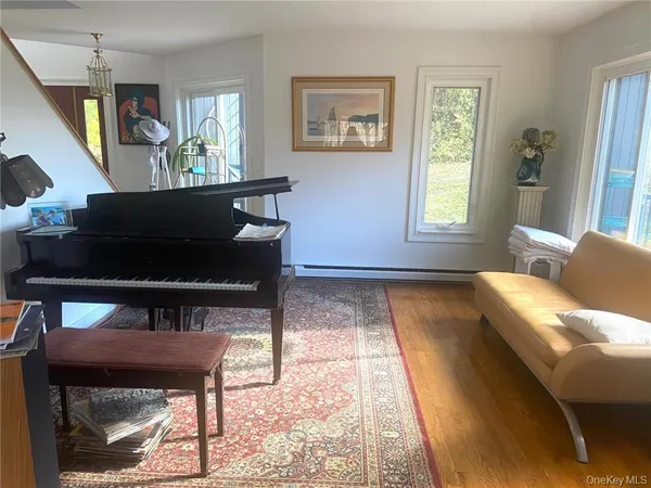 a living room with a bed furniture and a large window