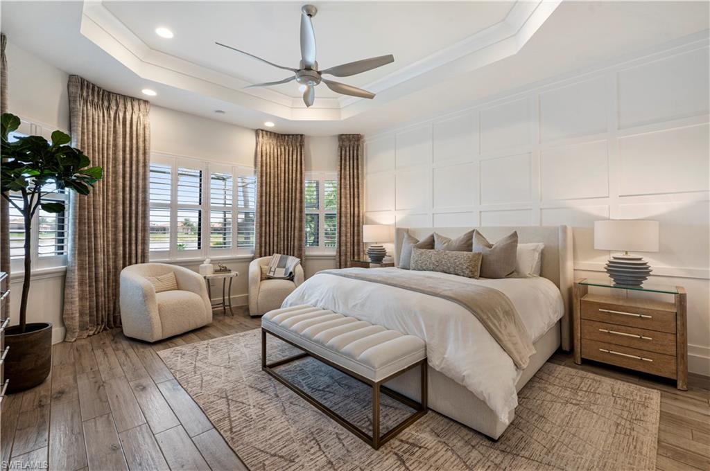4353 Caldera Circle Naples, FL 34119 - Photo 14 of 40 a spacious bedroom with a bed and a couch
