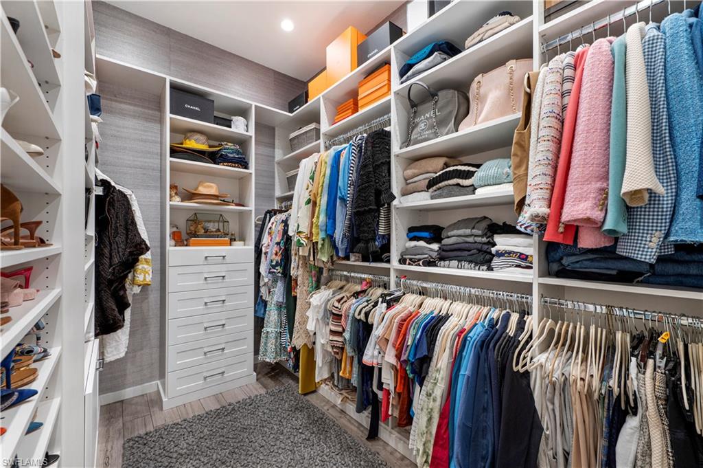 4353 Caldera Circle Naples, FL 34119 - Photo 16 of 40 a view of walk in closet with clothes and shoes