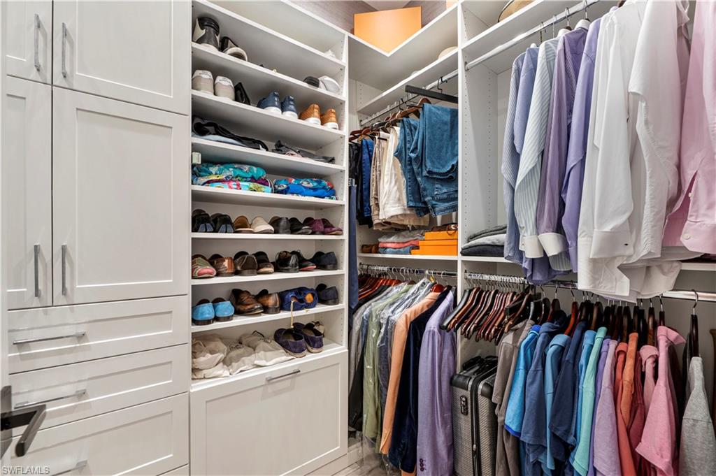 4353 Caldera Circle Naples, FL 34119 - Photo 17 of 40 a view of walk in closet with clothes and shoes