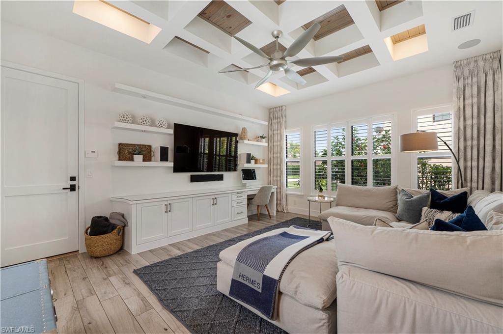 4353 Caldera Circle Naples, FL 34119 - Photo 22 of 40 a living room with a bed furniture flat screen tv and a large window