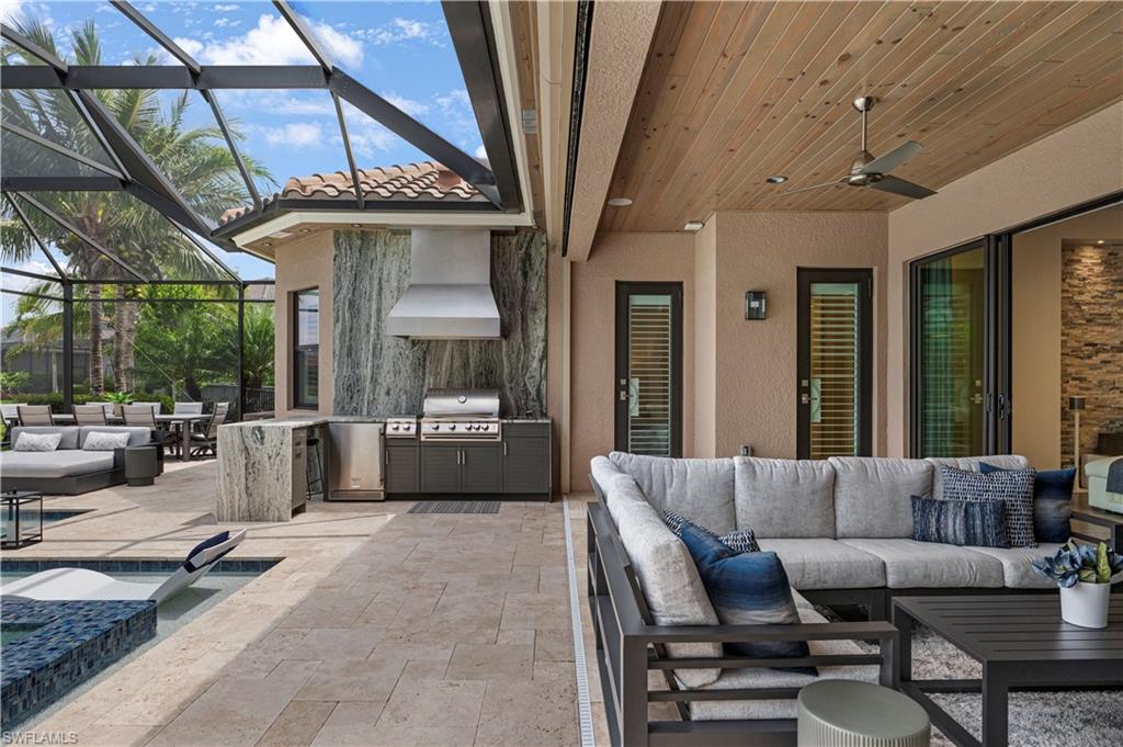 4353 Caldera Circle Naples, FL 34119 - Photo 25 of 40 a living room with furniture a window and a chandelier