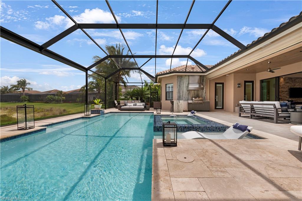 4353 Caldera Circle Naples, FL 34119 - Photo 28 of 40 a view of a swimming pool with a patio