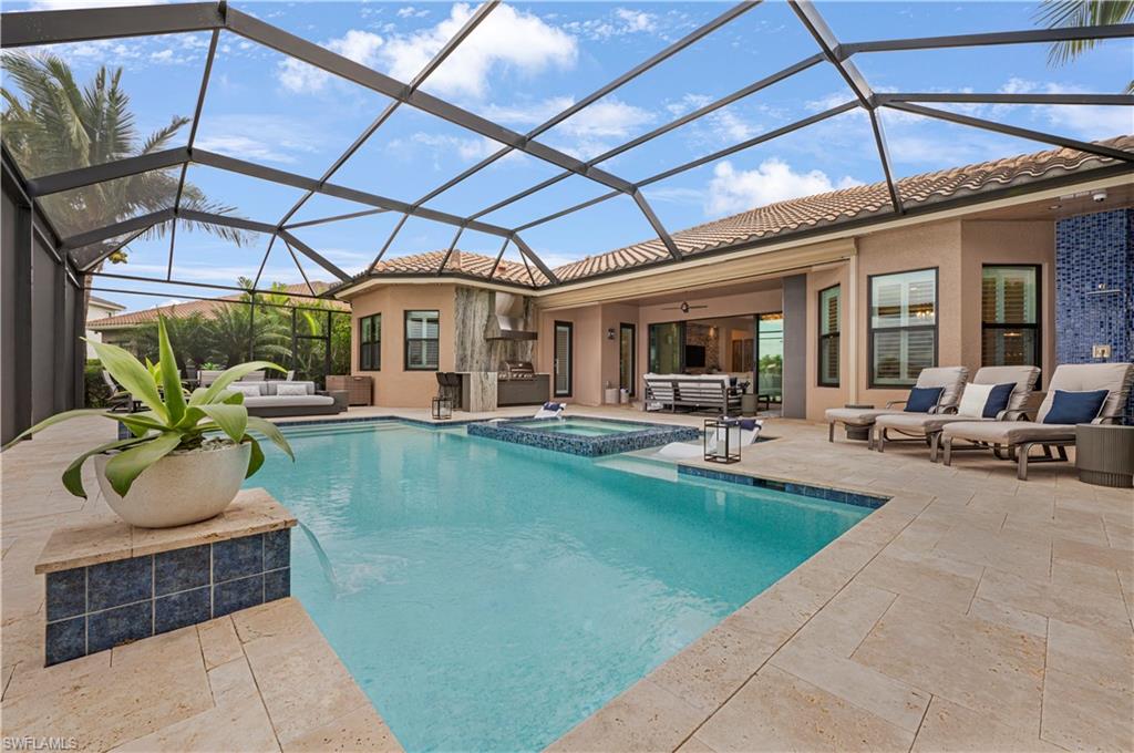 4353 Caldera Circle Naples, FL 34119 - Photo 29 of 40 a view of a patio with couches chairs and potted plants