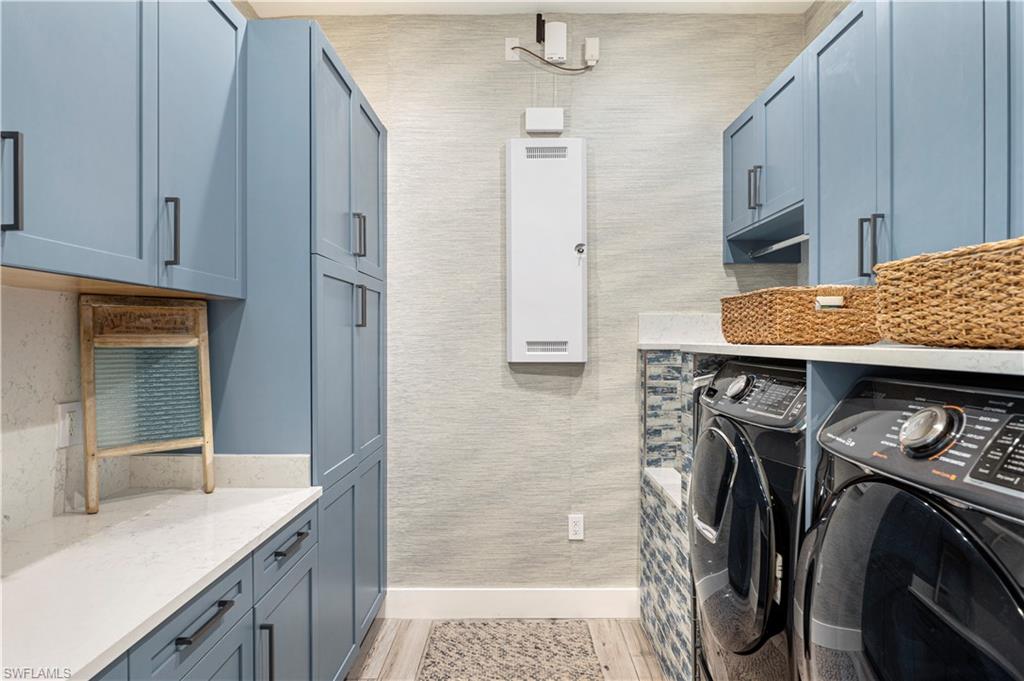 4353 Caldera Circle Naples, FL 34119 - Photo 32 of 40 a utility room with cabinets