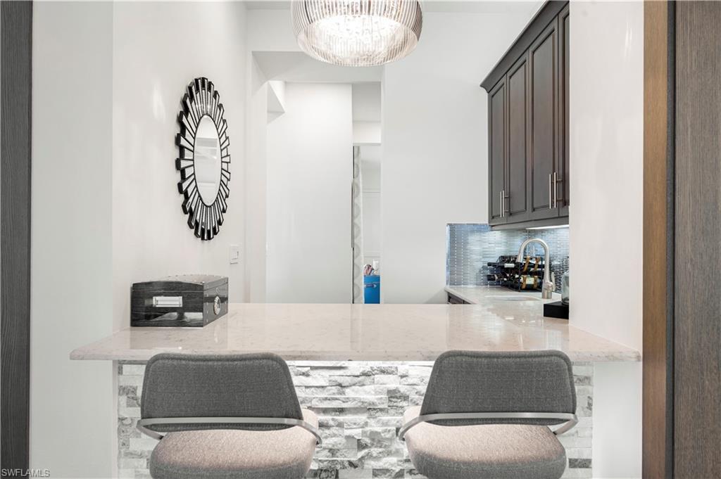 4353 Caldera Circle Naples, FL 34119 - Photo 34 of 40 a living room with furniture and a mirror