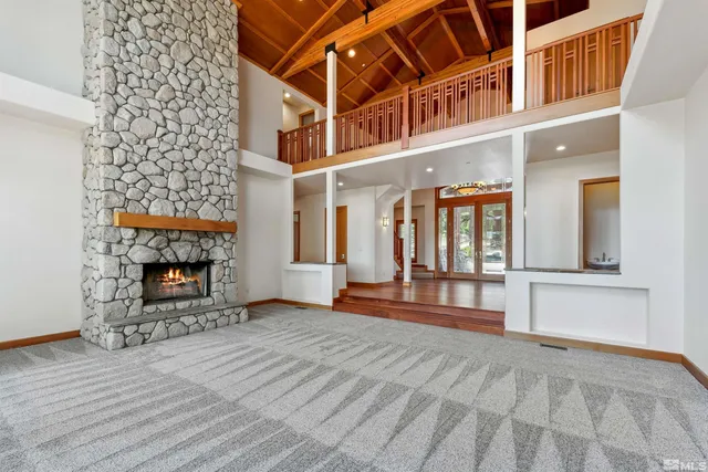 a view of an empty room with window and fireplace