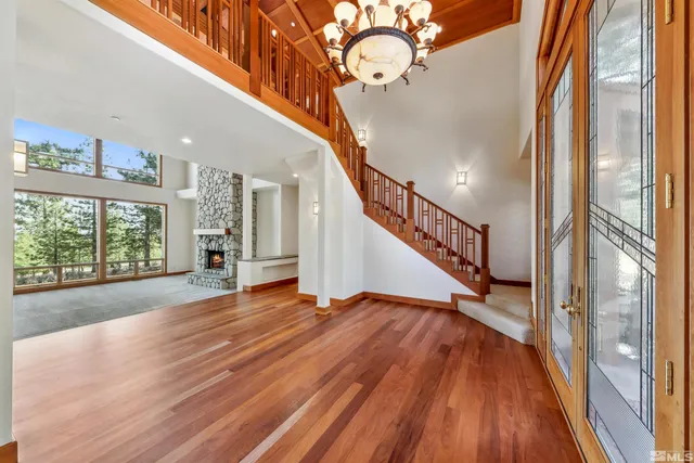 a view of entryway and hall with wooden floor