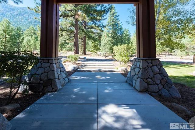 a view of a patio with table and chairs and wooden floor