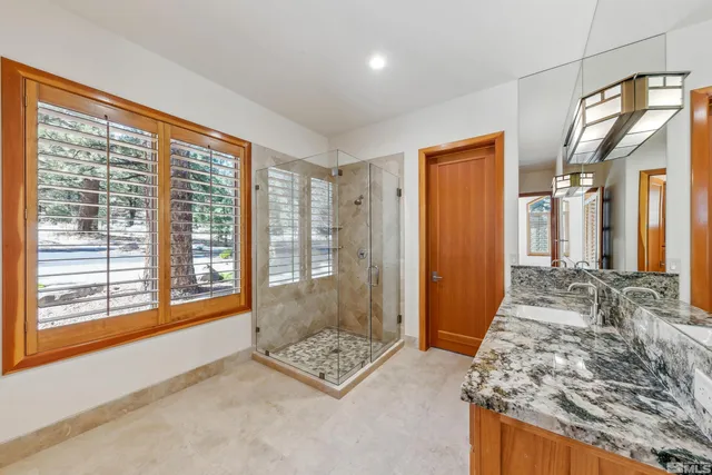 a spacious bedroom with a large window and walk in closet