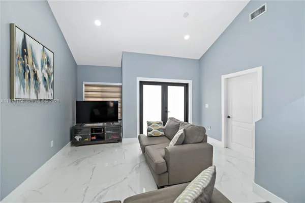a living room with furniture and a flat screen tv