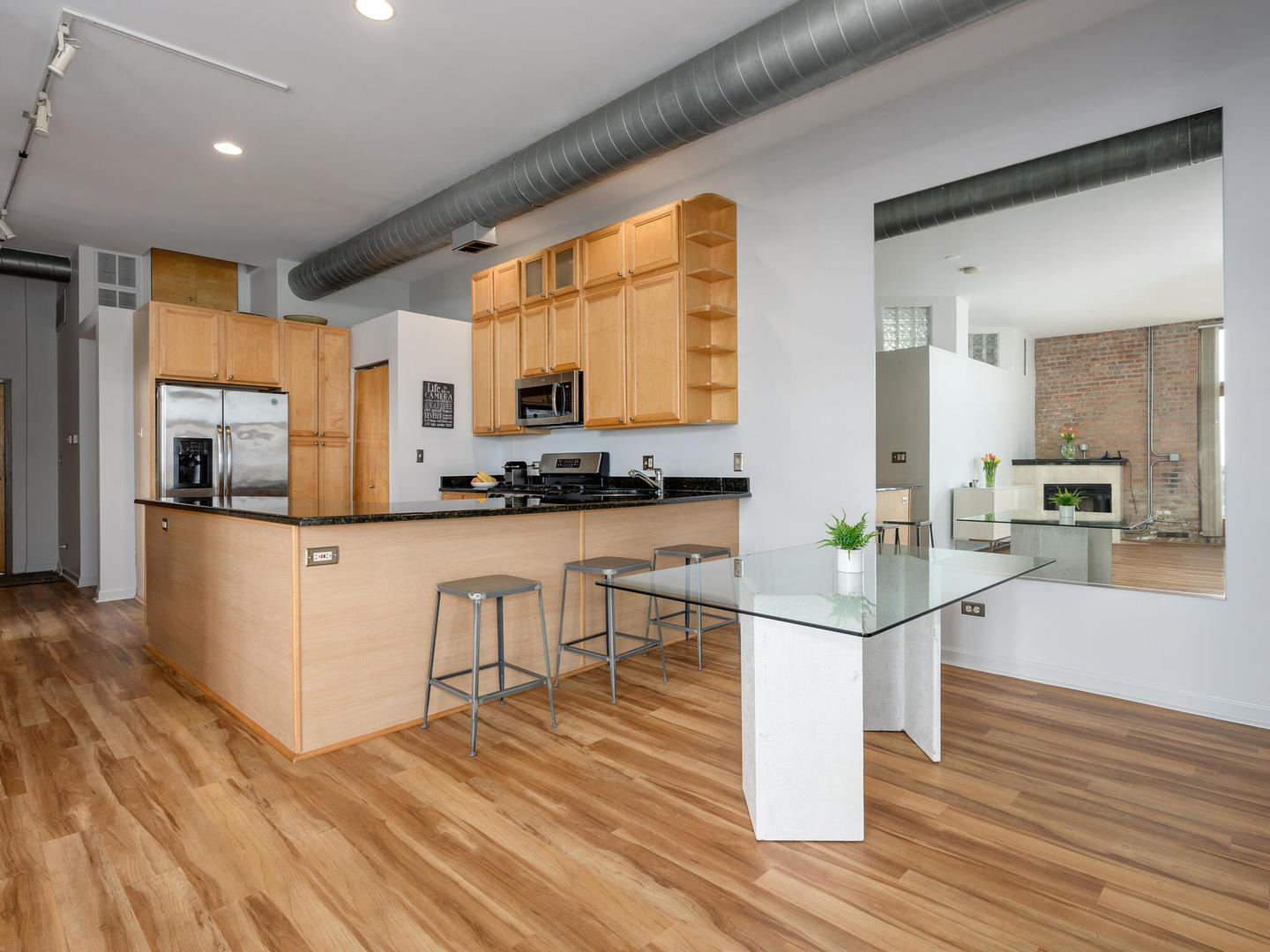 2101 West Rice Street, Unit 408 Chicago, IL 60622 - Photo 2 of 12 a kitchen with white cabinets and stainless steel appliances