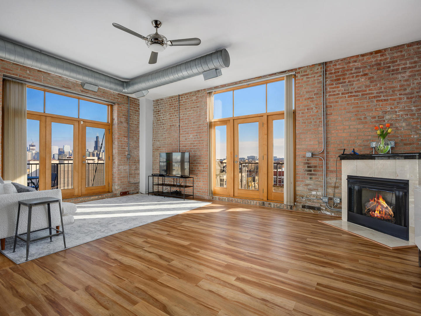 2101 West Rice Street, Unit 408 Chicago, IL 60622 - Photo 3 of 12 a view of an empty room with wooden floor fireplace and a window