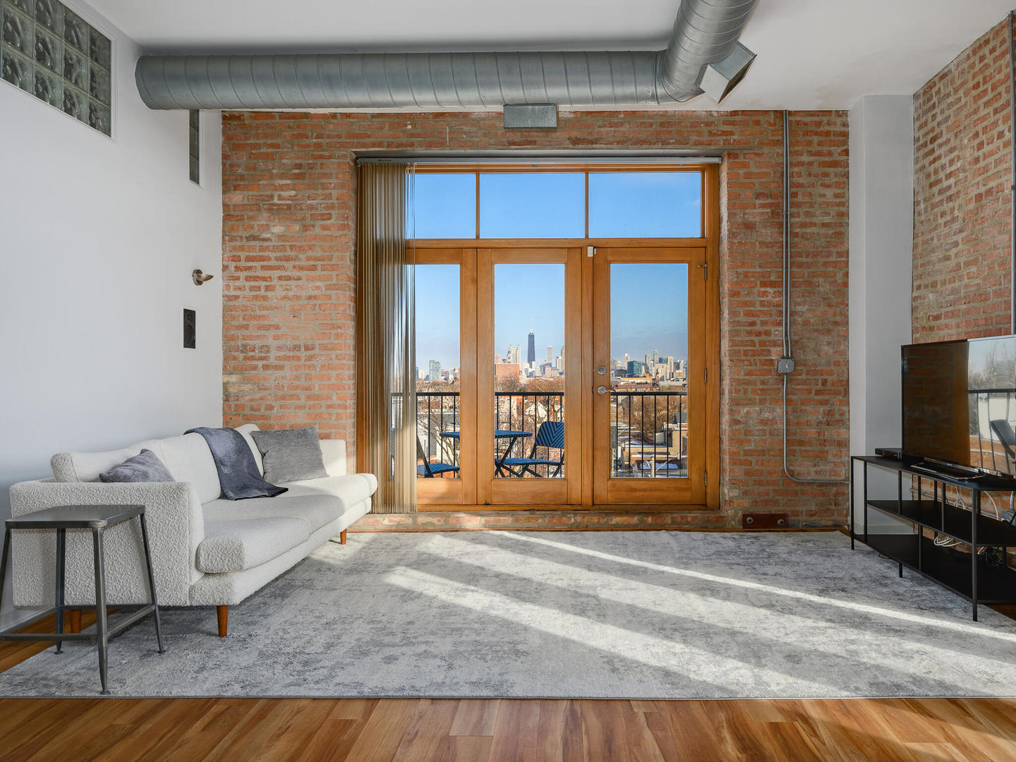 2101 West Rice Street, Unit 408 Chicago, IL 60622 - Photo 4 of 12 a living room with furniture and a flat screen tv