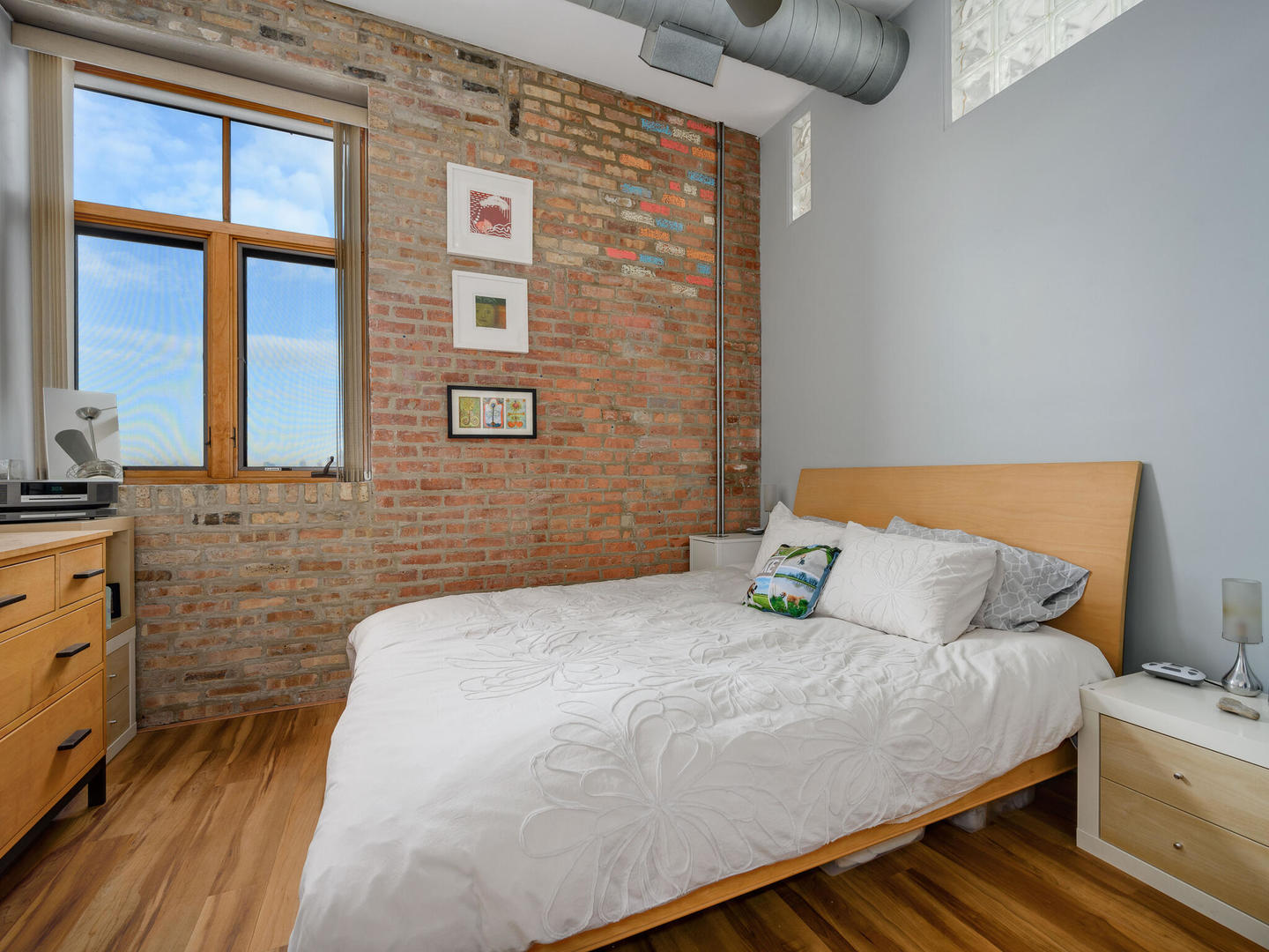 2101 West Rice Street, Unit 408 Chicago, IL 60622 - Photo 10 of 12 a bedroom with a bed and a cabinets