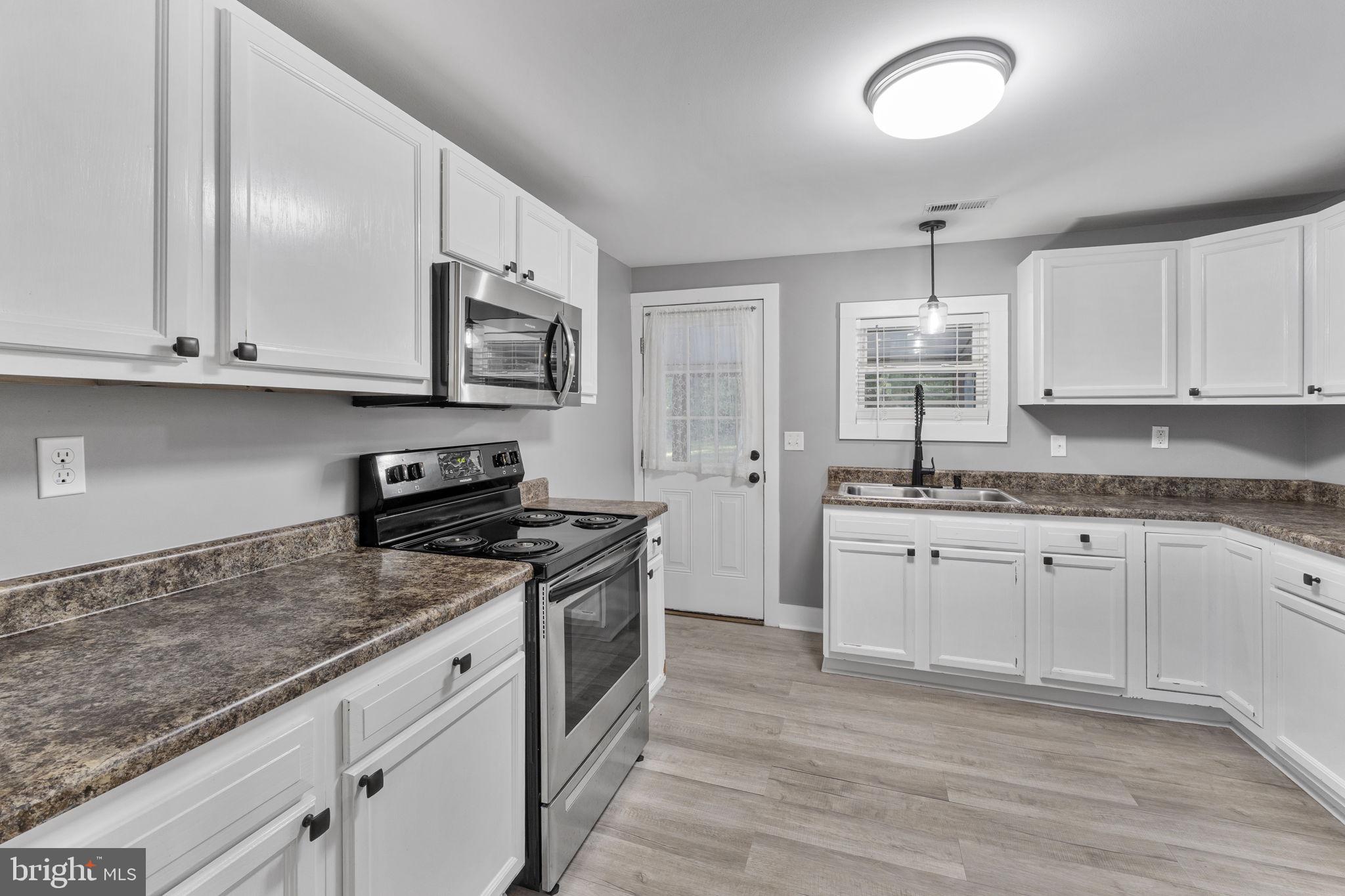20455 Monrovia Road Orange, VA 22960 - Photo 11 of 41 a kitchen with stainless steel appliances granite countertop a sink stove and cabinets