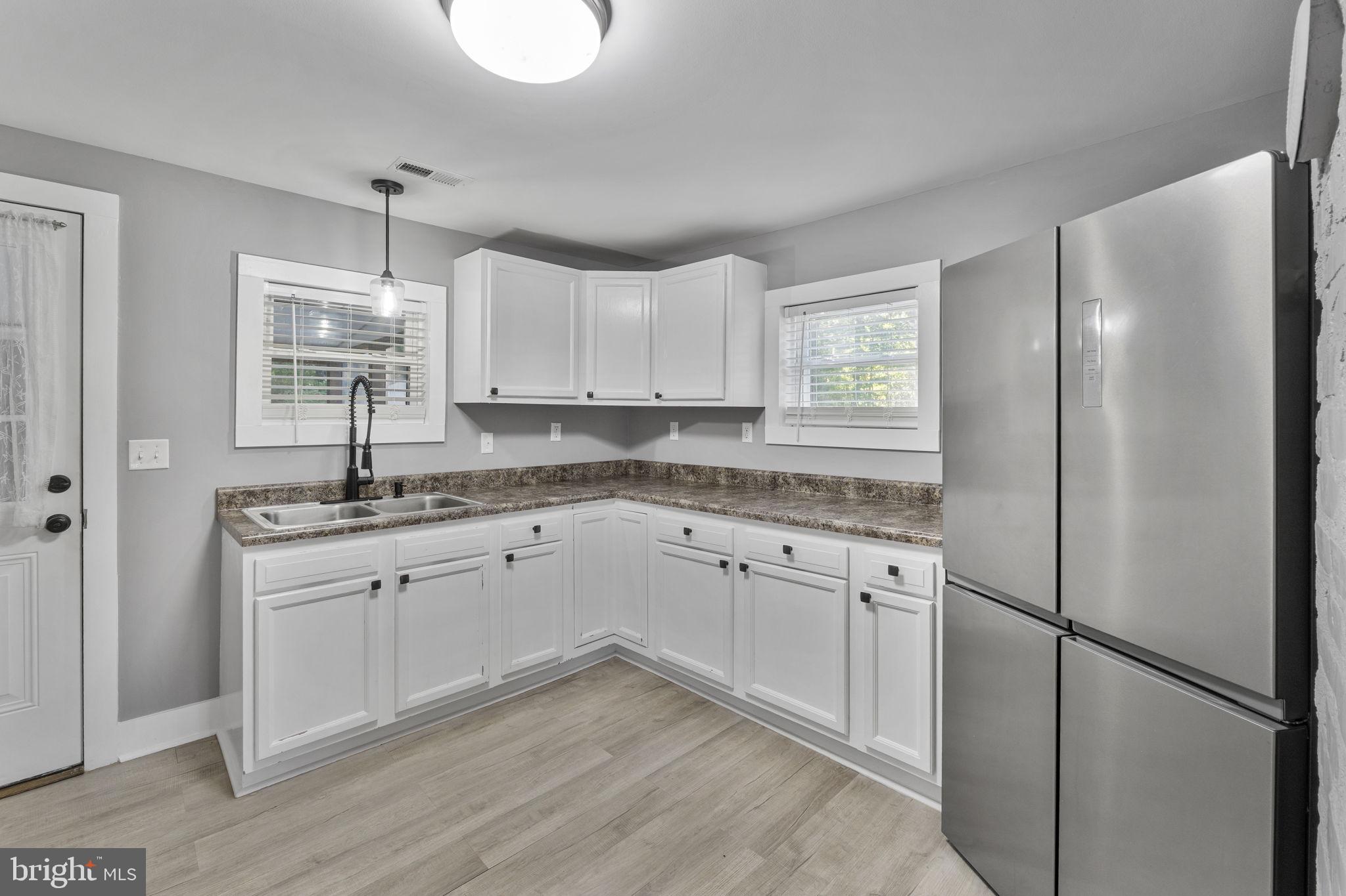 20455 Monrovia Road Orange, VA 22960 - Photo 12 of 41 a kitchen with granite countertop white cabinets and white appliances