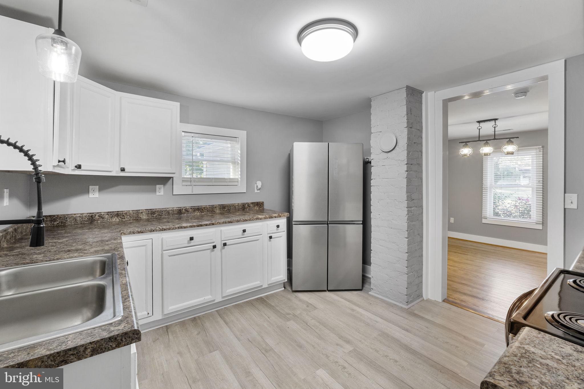 20455 Monrovia Road Orange, VA 22960 - Photo 14 of 41 a kitchen with stainless steel appliances granite countertop a refrigerator sink and white cabinets