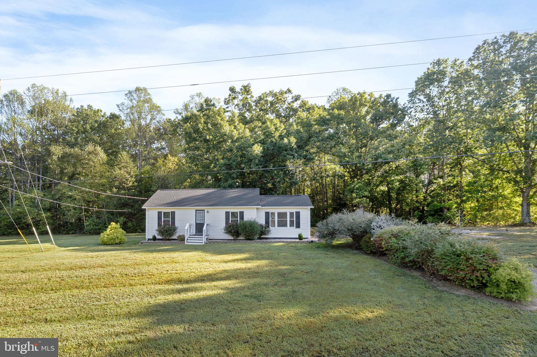 20455 Monrovia Road Orange, VA 22960 - Photo 2 of 41 a front view of a house with a garden and trees