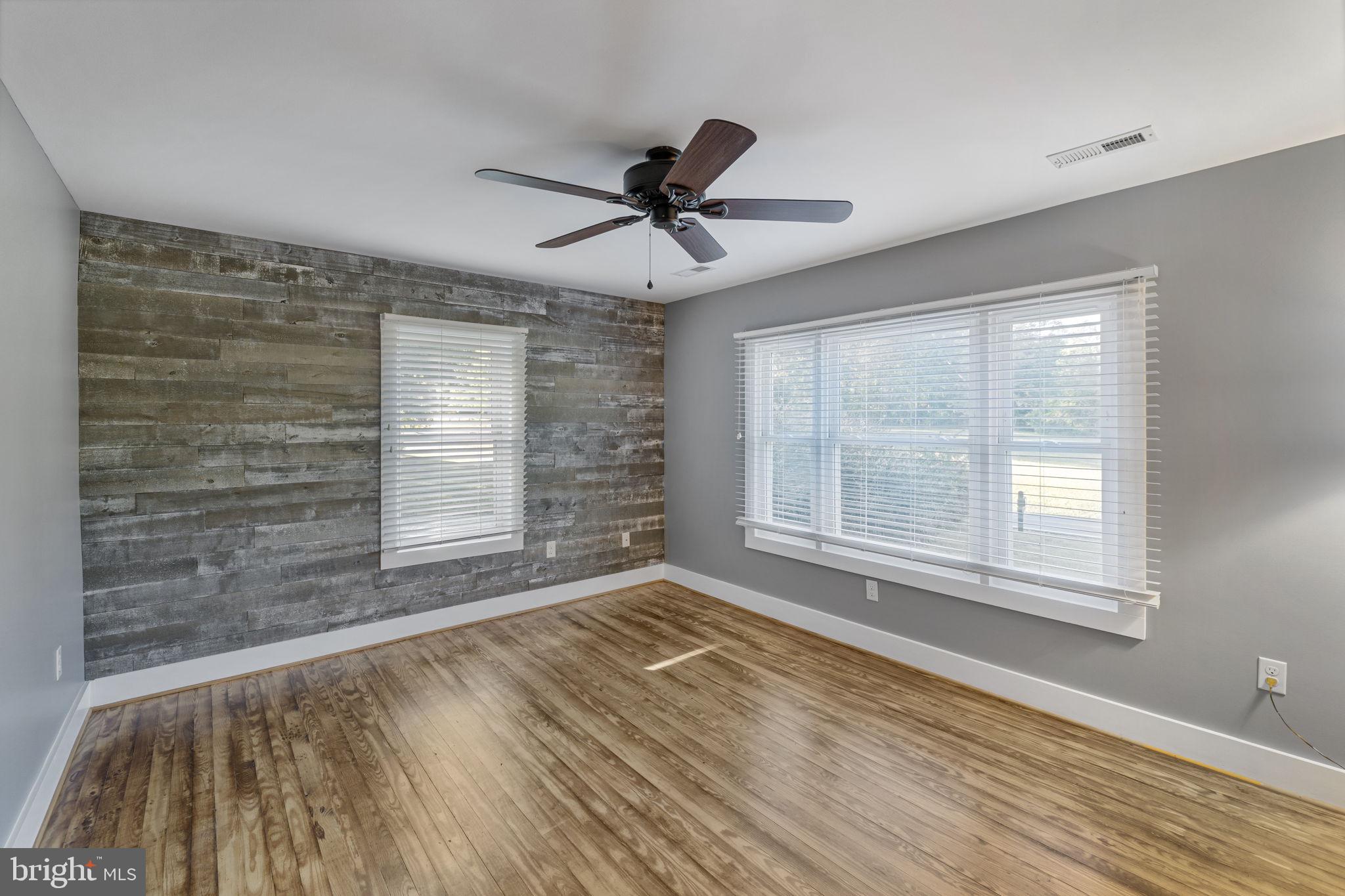 20455 Monrovia Road Orange, VA 22960 - Photo 8 of 41 a view of empty room with wooden floor and fan