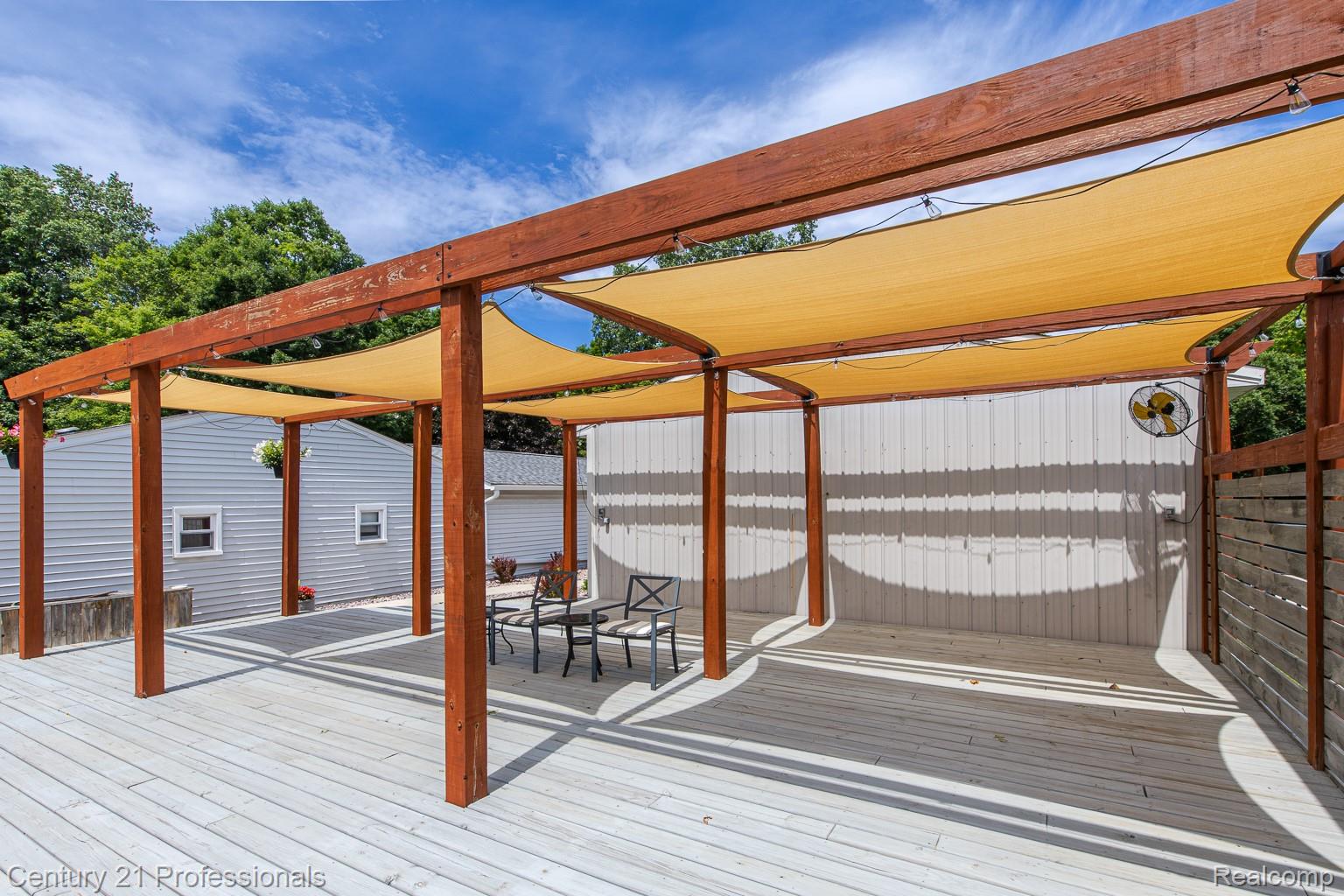 1790 Kent Road Ortonville, MI 48462 - Photo 40 of 64 Expansive outdoor deck featuring a rich wood pergola with integrated shade sails