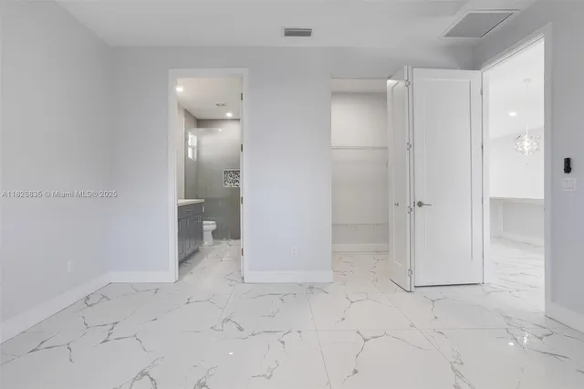 a bathroom with a granite countertop sink a toilet and a mirror