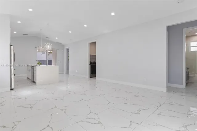 a view of a hallway with cabinet and entryway