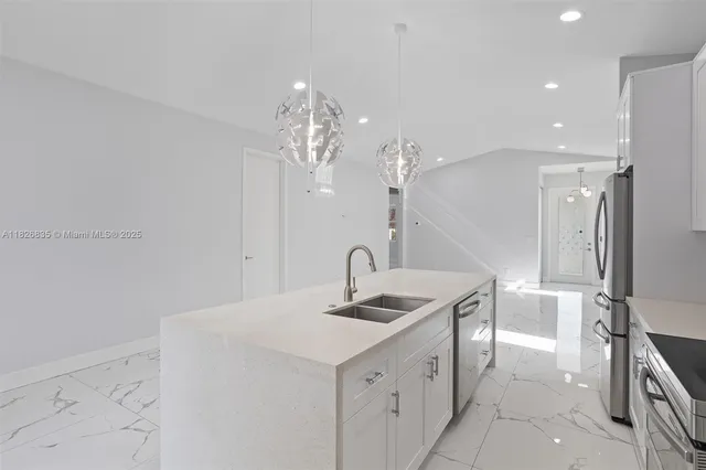 a kitchen with a sink and refrigerator