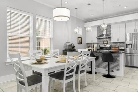 a kitchen with a dining table and chairs