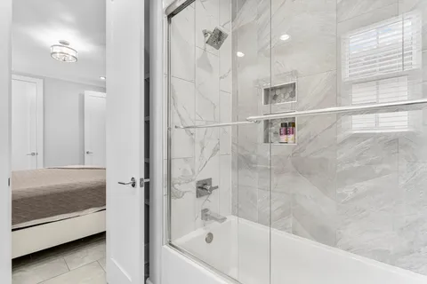 a bathroom with a bathtub and a shower
