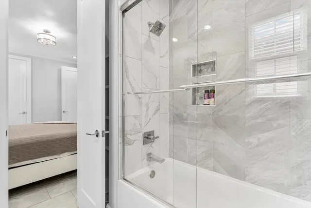 a bathroom with a bathtub and a shower