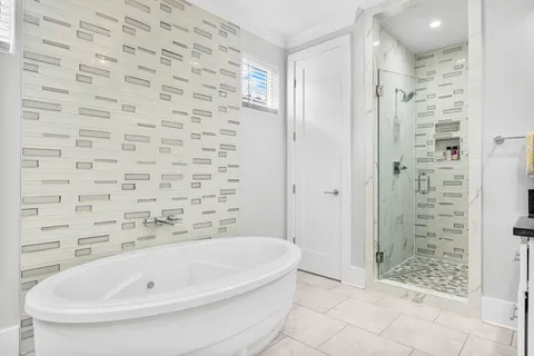 a bathroom with a bathtub and shower