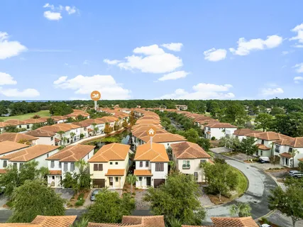 an aerial view of residential houses with outdoor space and street view