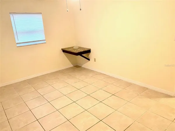 a view of an empty room and a window