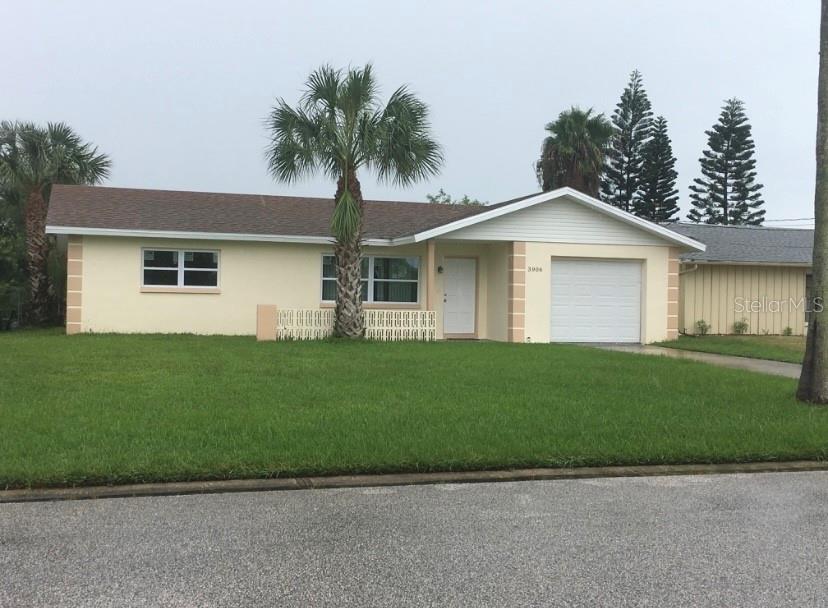 3906 Headsail Drive New Port Richey, FL 34652 - Photo 2 of 21 a front view of a house with a garden and yard