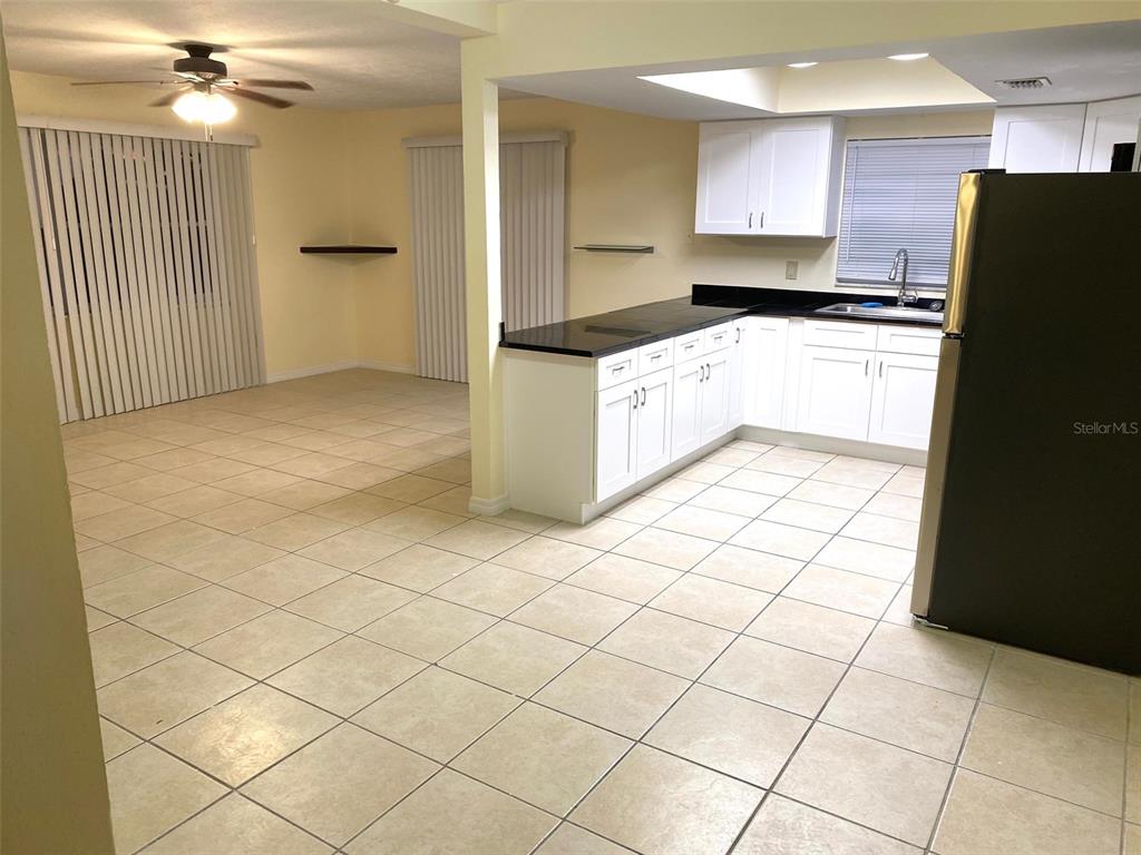 3906 Headsail Drive New Port Richey, FL 34652 - Photo 3 of 21 a kitchen with granite countertop a refrigerator and a stove top oven