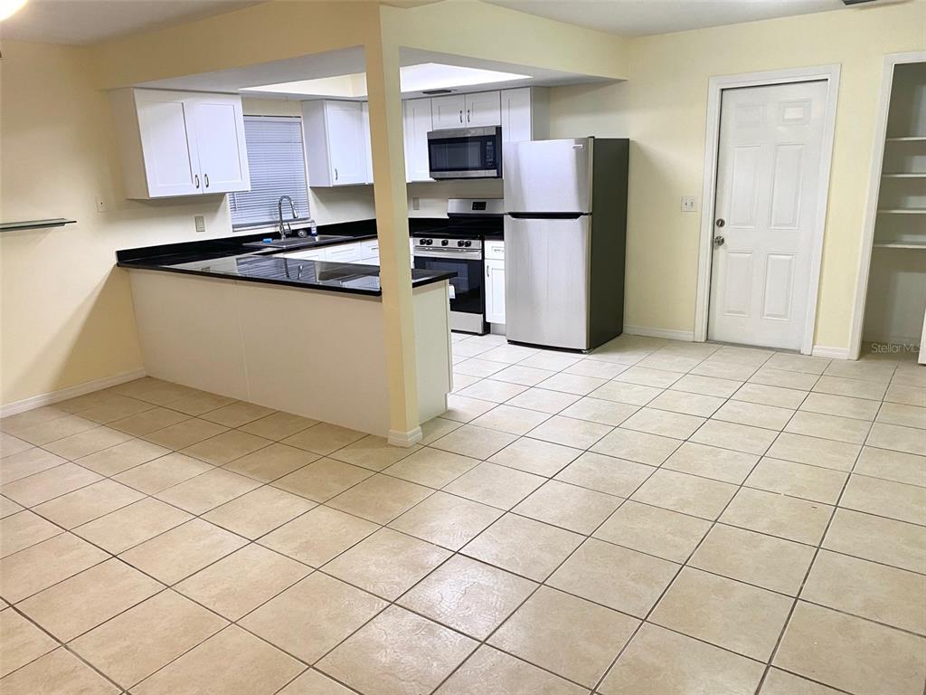 3906 Headsail Drive New Port Richey, FL 34652 - Photo 5 of 21 a kitchen with stainless steel appliances a refrigerator sink and microwave