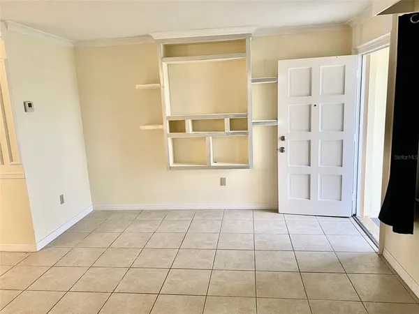 a view of a livingroom with an empty space and a window