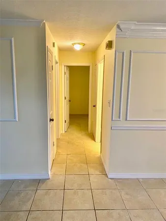 a view of a hallway to rooms