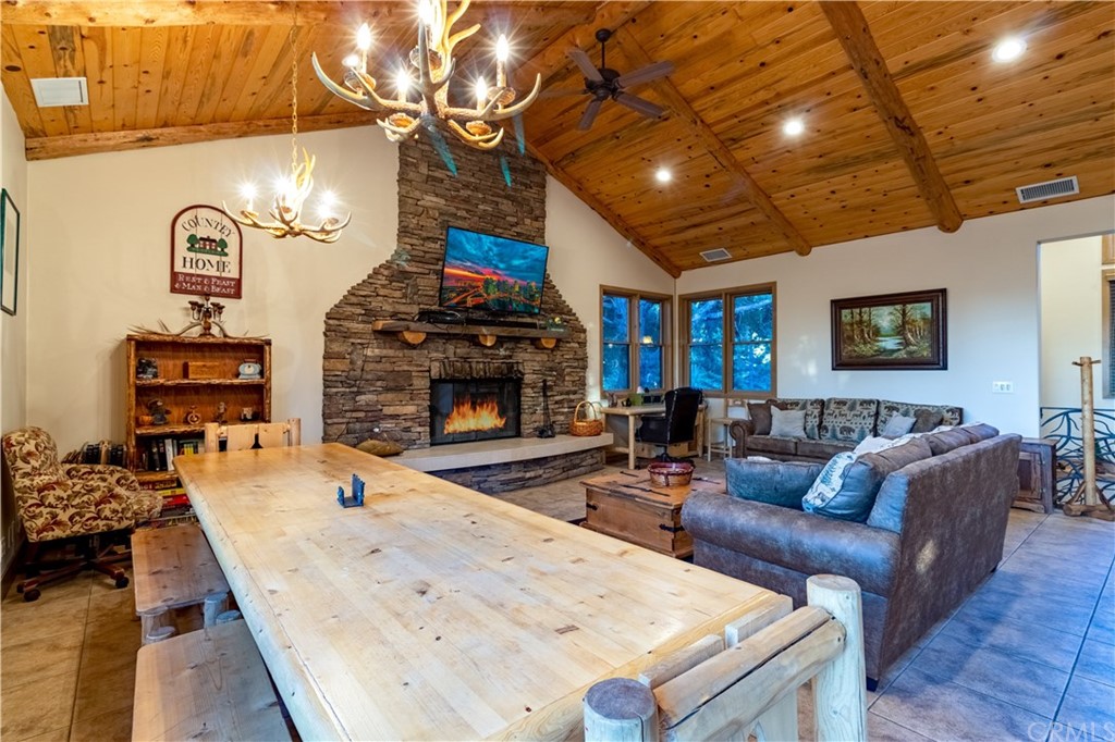 43490 Primrose Drive Big Bear Lake, CA 92315 - Photo 13 of 69 a living room with furniture a fireplace and a flat screen tv