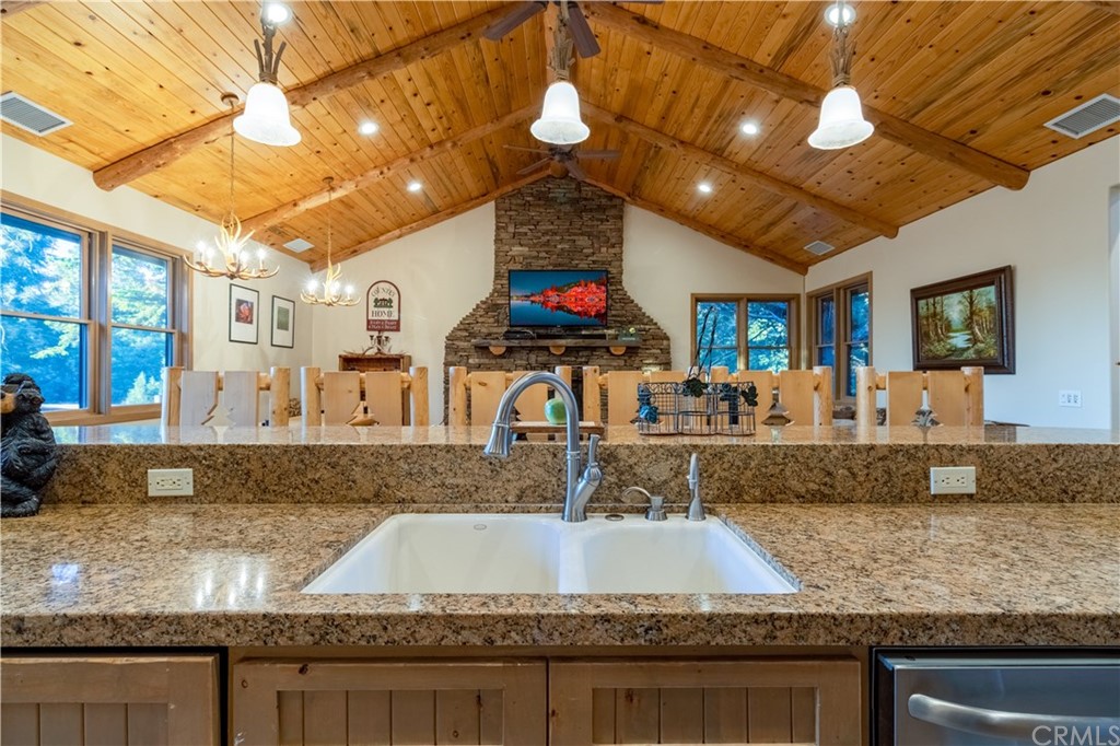 43490 Primrose Drive Big Bear Lake, CA 92315 - Photo 15 of 69 a kitchen with stainless steel appliances granite countertop a sink a stove and a wooden cabinets