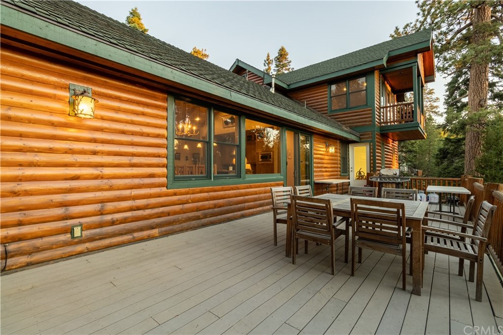43490 Primrose Drive Big Bear Lake, CA 92315 - Photo 23 of 69 a view of a patio with table and chairs and wooden floor
