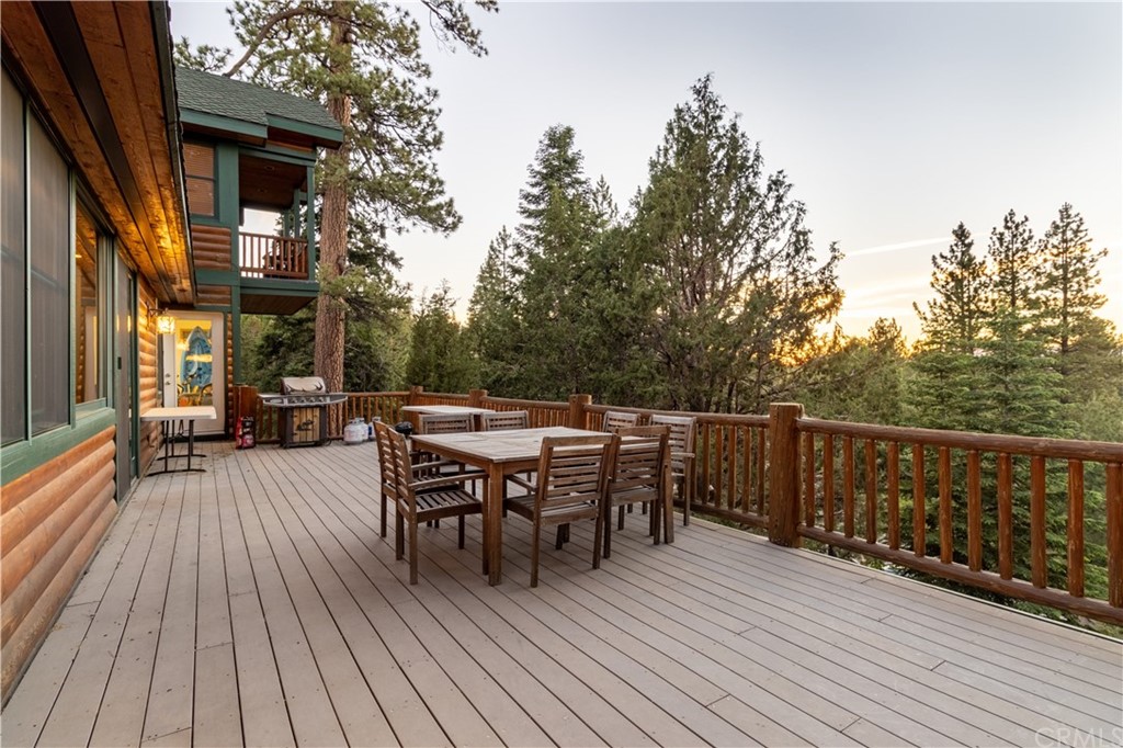 43490 Primrose Drive Big Bear Lake, CA 92315 - Photo 24 of 69 a view of a roof deck with table and chairs and wooden floor