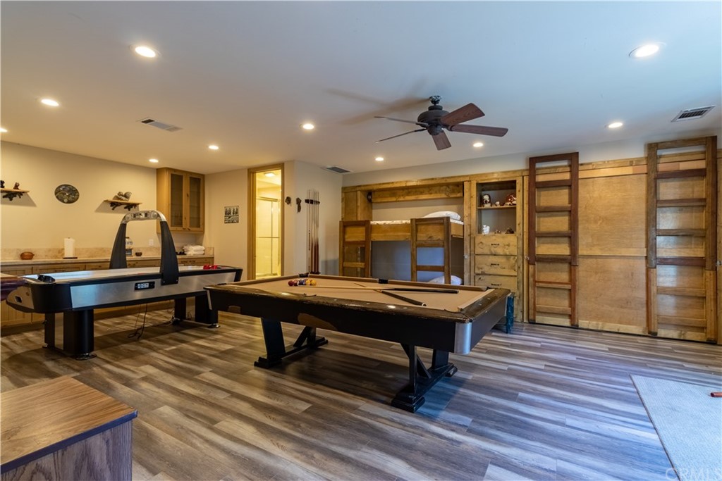 43490 Primrose Drive Big Bear Lake, CA 92315 - Photo 37 of 69 a living room with furniture a table and wooden floor
